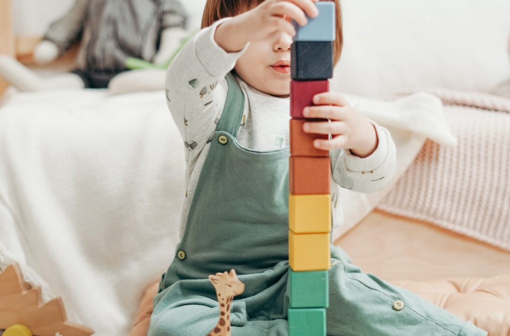 child-in-white-long-sleeve-top-and-dungaree-trousers-playing-3661356